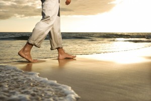 Legs walking on beach