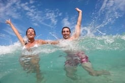 Cheerful couple swimming in the ocean