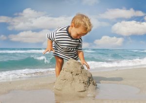 baby boy playing on beach
